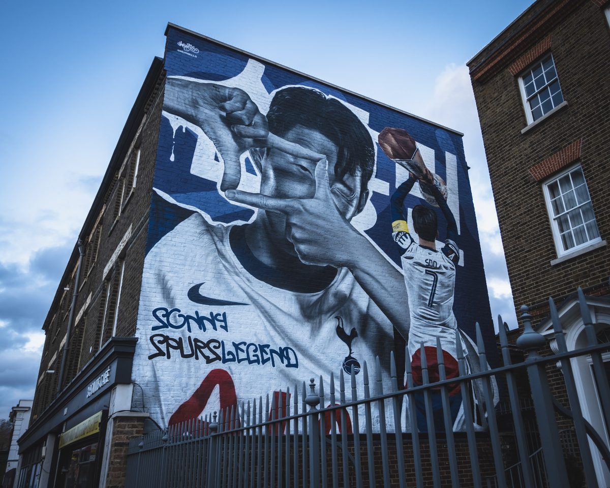 A mural of Son Heung-min covering the side of a building near the stadium, lettered Sonny Spurs Legend.